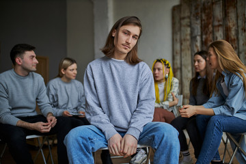stressful caucasian male is member of alcoholics club, he want to get rid of addiction, sit apart...
