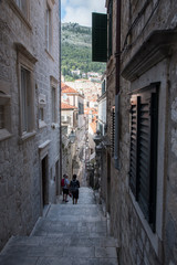 Narrow street on slope with stone stairs in Dubrovnik, Croatia, Europe.