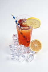 Ice lemon tea with ice cube yellow lemon slice blue white paper straw on white background