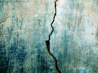 
Crack in the wall of the building. Blurred defocused background for web design.