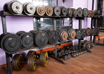 Fototapeta na wymiar Old gym interior with old school dumbbells and equipment