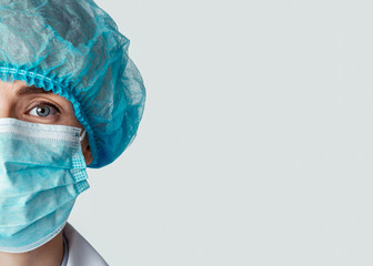 Half face of woman doctor in protective mask and hat