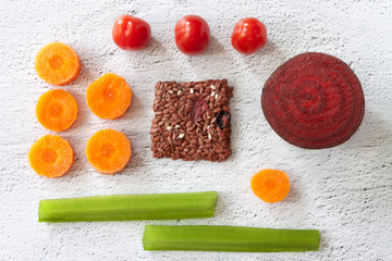 Flat lay above view square crunchy flax seeds crispbread with beet and raw round organic vegetables on white background. Healthy snack: cereal multigrain flax seed, sesame, flaxseed, tomatoes, carrots