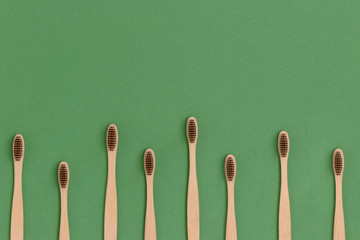 Frame made of toothbrushes on a green background. Plastic free concept.