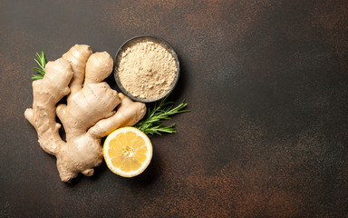 Ginger root, ginger powder and lemon on vintage background