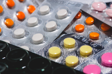 Many colorful tablets in a blister pack. The concept of the pharmaceutical industry. Pharmacy-Pharmacy.