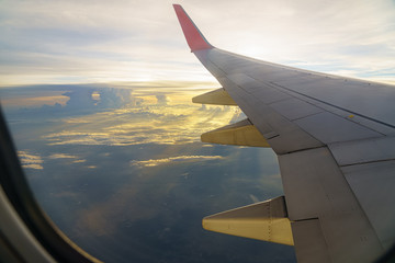 Fototapeta premium Beautiful sunset, sky on the top view, airplane flying view from inside window aircraft of traveling to travel alone onely time.