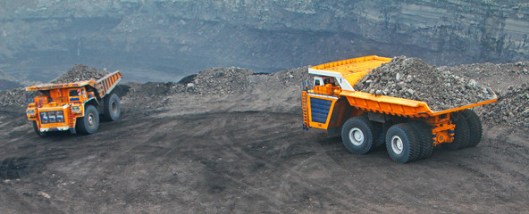 Heavy truck in a quarry transports coal loading excavator © Ramil
