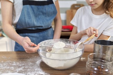 Children mix flour in bowl, add ingredients