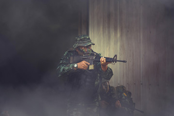 Special forces. soldier assault rifle with silencer. sniper in the forest. 