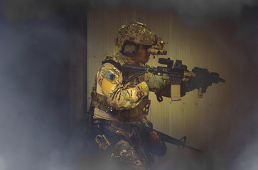 Special forces. soldier assault rifle with silencer. sniper in the forest. 