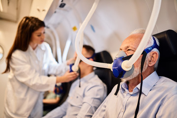 Senior man receiving hyperbaric oxygen therapy.