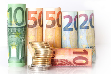 Several hundred rolls of euro banknotes in different positions