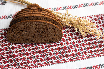 black bread and oats on the rustic tablecloth