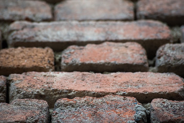 Holes in a damaged brick wall, soft focus