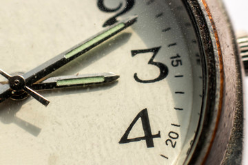 Close up of an old vintage watch. Macro photo of a figure in a wrist watch. Shabby watches.