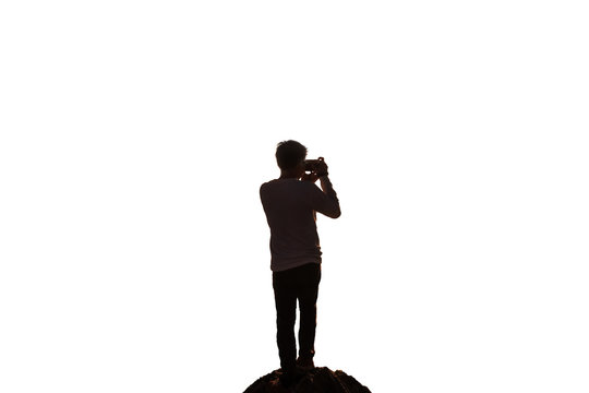 Silhouette Man Traveler Standing With Taking Photo From Retro Camera On Rock