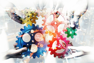 Business team connect pieces of gears. Teamwork, partnership and integration concept. double exposure with light effects