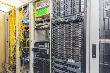 Powerful computing hardware works in the data center racks. Central technical platform of the Internet provider. There is a lot of telecommunications equipment in the server room.