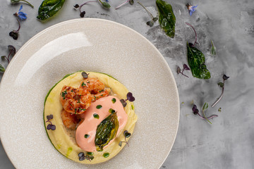 Latino american main course mofongo with shrimps and broth close-up on a plate on the table. horizontal top view from above
