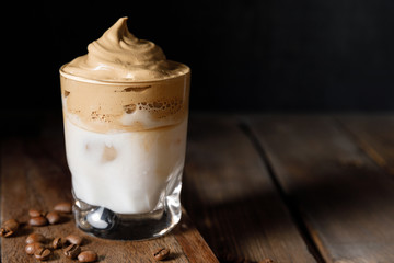 The Korean coffee drink dalgona on dark wooden background