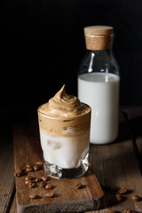 The Korean coffee drink dalgona on dark wooden background
