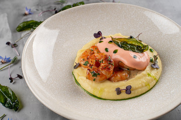 Latino american main course mofongo with shrimps and broth close-up on a plate on the table. horizontal top view from above