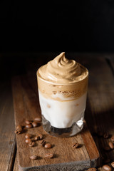 The Korean coffee drink dalgona on dark wooden background