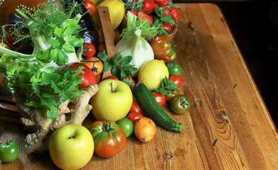 rustic composition of fruits and vegetables on wooden table top view illuminated by a warm light