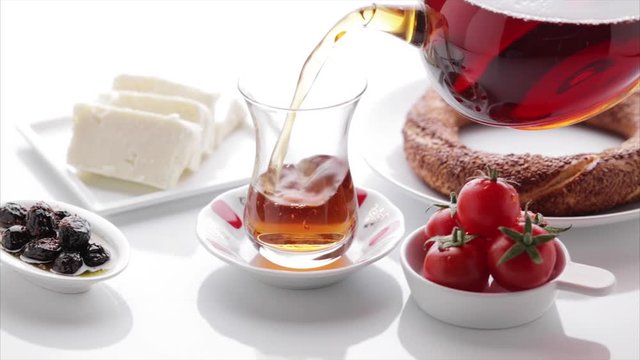 Turkish tea, simit, tomato, olive, cheese on isolated white background