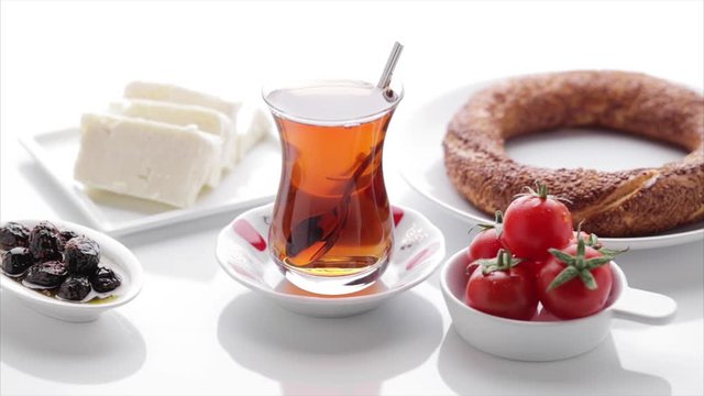 Turkish tea, simit, tomato, olive, cheese on isolated white background