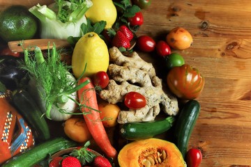 rustic composition of fruits and vegetables on wooden table top view illuminated by a warm light