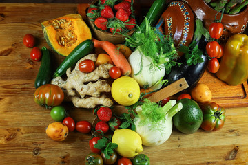 rustic composition of fruits and vegetables on wooden table top view illuminated by a warm light