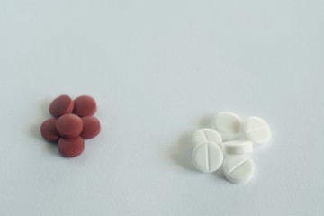pile of red and white pills on blue background with copy space. medicine concept