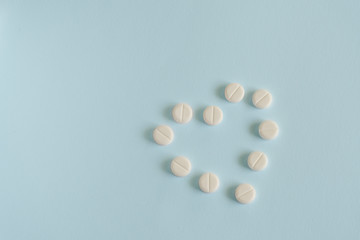 heart made up of pills on blue background. medicine concept