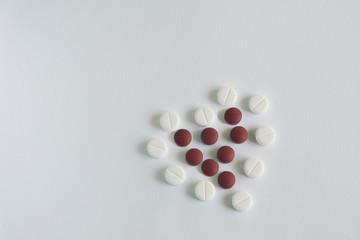 heart made up of pills on blue background. medicine concept