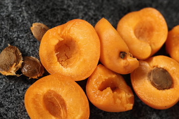 Fresh apricot halves on granite table