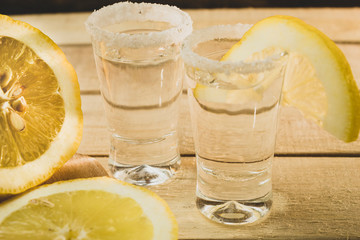 Glass with tequila and lemon and salt