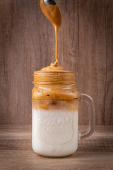 Iced Dalgona Coffee, a trendy fluffy creamy whipped coffee. South Korean drink.