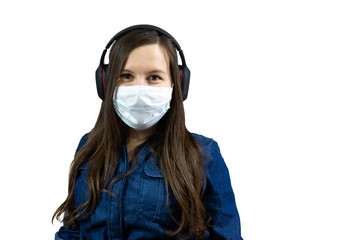 woman protect against the Corona Virus. girl wears headphones, protective mask and listens to music at home on isolation