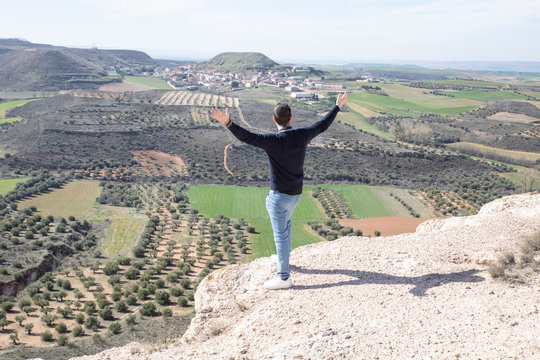 Photographs taken in the field in Guadalajara, Spain. Man from behind looking at the landscape from the top of a hillside