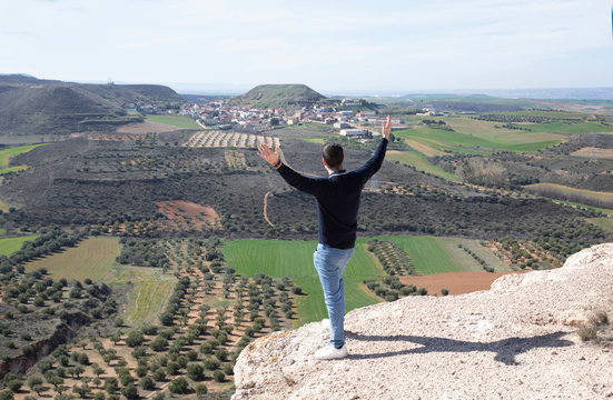 Photographs taken in the field in Guadalajara, Spain. Man from behind looking at the landscape from the top of a hillside