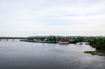 Fototapeta na wymiar View of the industrial embankment and Petrovsky railway bridge over the Dnipro River in Kyiv, Ukraine