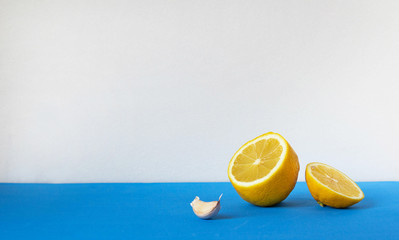 cut lemon and garlic on a blue table. Immunostimulating products