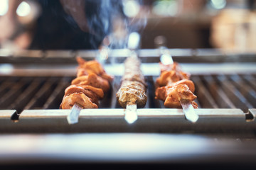 Preparation of shish kebab bbq.  Grilled pork on a white plate on a wooden table. Grilled pork skewers - 341415922