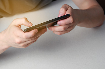 using a telephone to play or work at a table by a white man