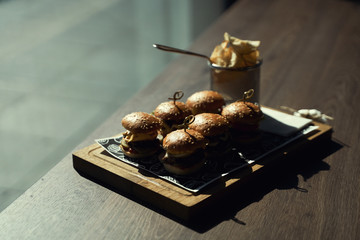Craft beef burger and french fries on wooden table isolated on black background. Hamburgers and French fries on the wooden tray. - 341417964