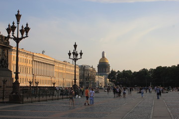 Petersburg, Russia - JULY 25 2018: Palace Square. People sitting on the cobbled road and rest on...