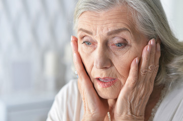 Close up portrait of sad ill senior woman