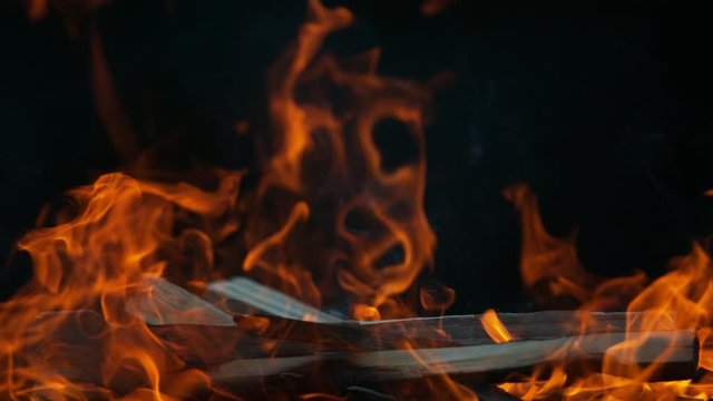 Super slow motion of flames with logs isolated on black background. Filmed on high speed cinema camera, 1000 fps